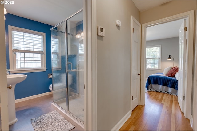 7067 N Dwight Ave, Portland, OR 97203 - bathroom with a shower stall, connected bathroom, and wood finished floors