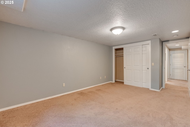 7067 N Dwight Ave, Portland, OR 97203 - unfurnished bedroom featuring light colored carpet, a textured ceiling, and a closet
