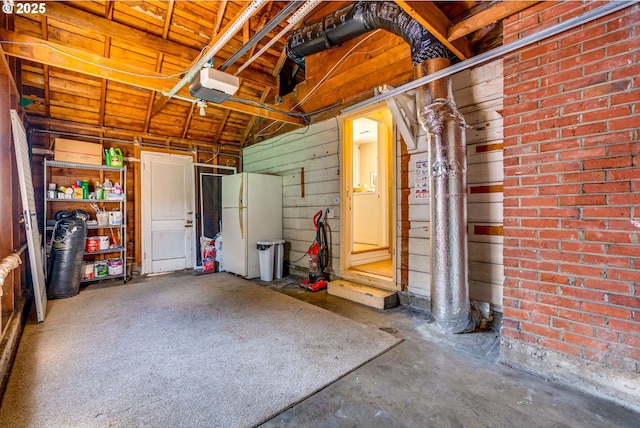 7067 N Dwight Ave, Portland, OR 97203 - garage with a garage door opener and freestanding refrigerator