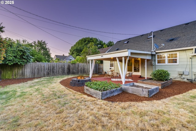 7067 N Dwight Ave, Portland, OR 97203 - fenced backyard with a patio, a vegetable garden, and an outdoor fire pit