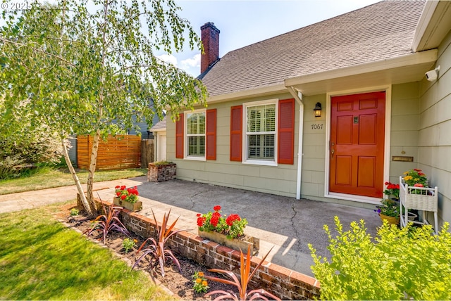 7067 N Dwight Ave, Portland, OR 97203 - doorway to property featuring a chimney and a shingled roof