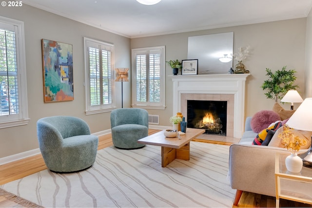 7067 N Dwight Ave, Portland, OR 97203 - living room with wood finished floors, a tile fireplace, and ornamental molding