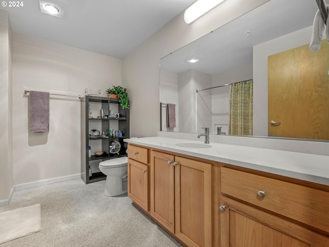 bathroom featuring vanity, curtained shower, and toilet