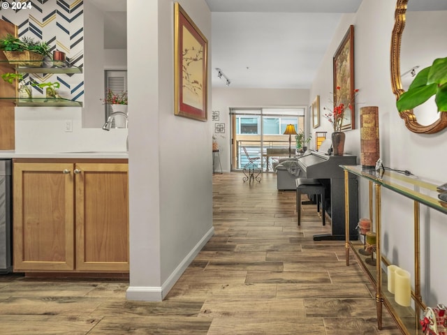 hallway featuring sink and track lighting