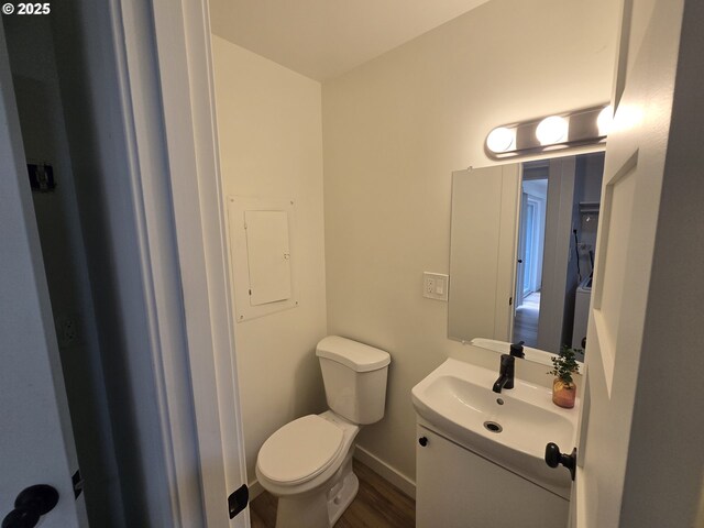 550 NE 20th Dr, Gresham, OR 97030 - half bathroom featuring vanity, wood finished floors, and electric panel