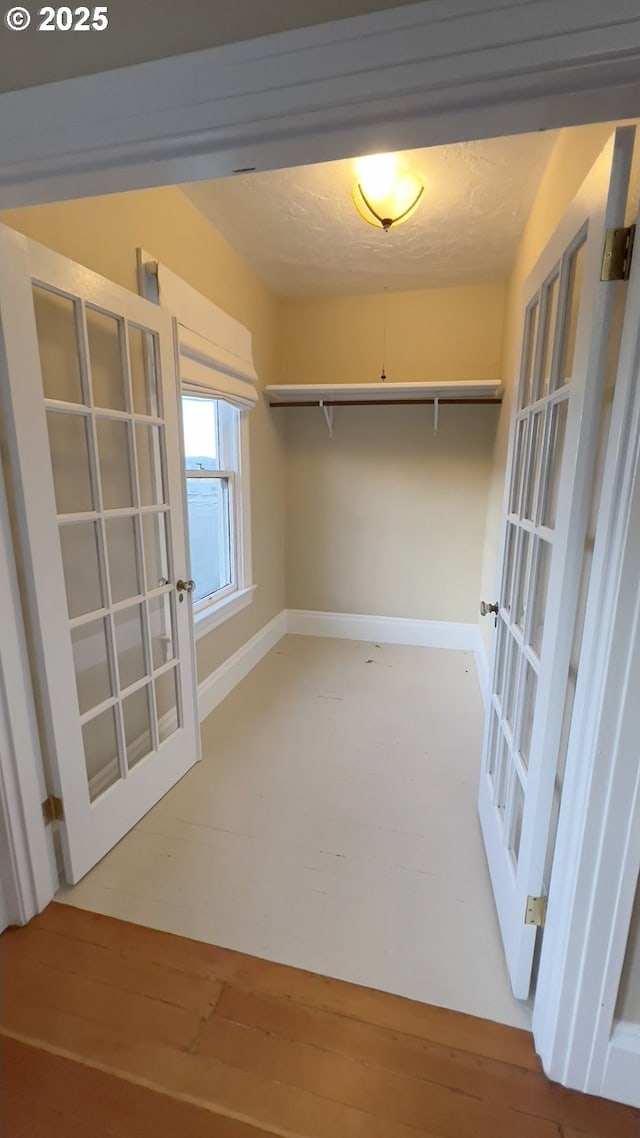 spacious closet featuring french doors