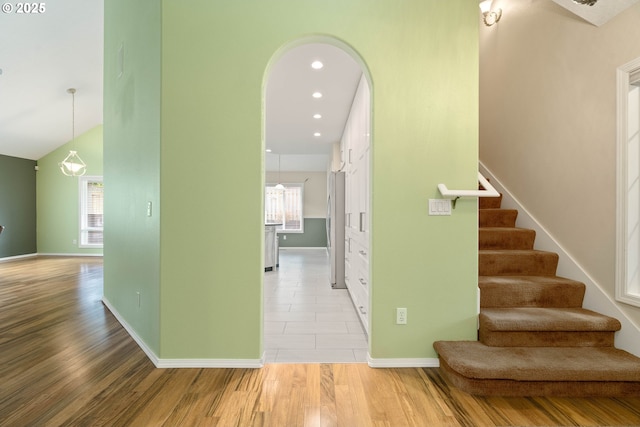 stairs with recessed lighting, wood finished floors, and baseboards