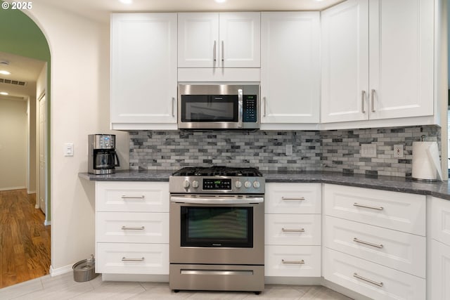 kitchen with visible vents, appliances with stainless steel finishes, and white cabinetry