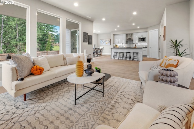 living room with recessed lighting and light wood-style flooring