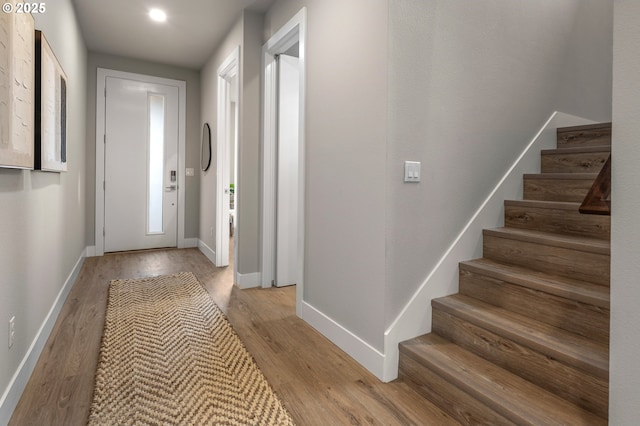 interior space featuring stairway, baseboards, and light wood-style flooring