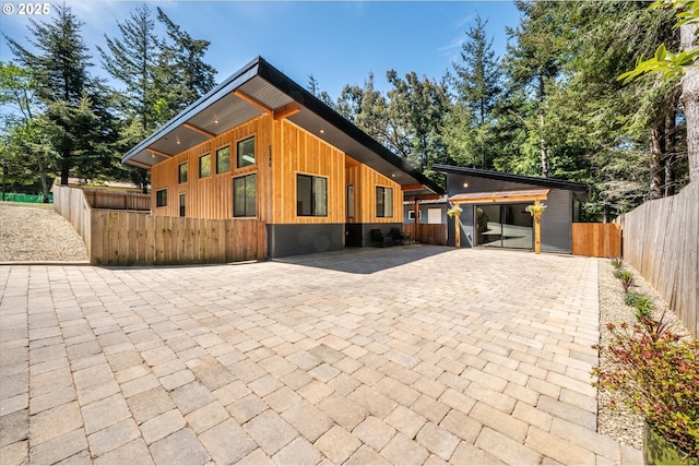 2345 Deady St, Port Orford, OR 97465 - contemporary home featuring board and batten siding, driveway, and fence