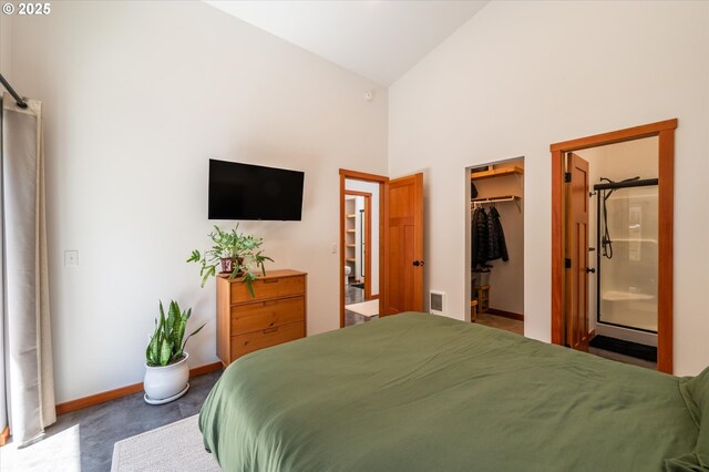 2345 Deady St, Port Orford, OR 97465 - carpeted bedroom featuring ensuite bathroom, high vaulted ceiling, visible vents, a spacious closet, and baseboards