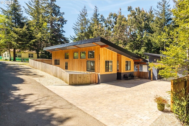 2345 Deady St, Port Orford, OR 97465 - view of side of property featuring board and batten siding, fence private yard, and decorative driveway
