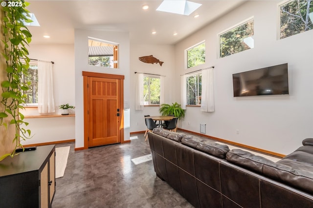 2345 Deady St, Port Orford, OR 97465 - living room featuring a towering ceiling, baseboards, a skylight, and recessed lighting
