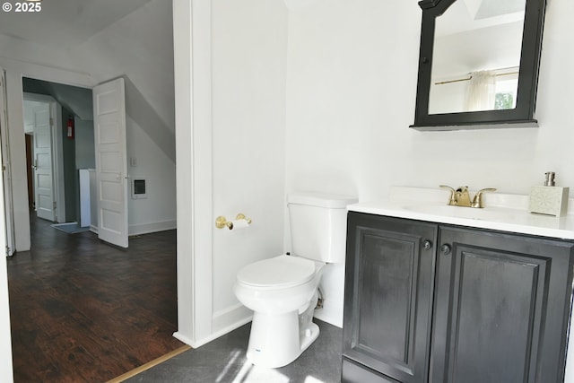 4820 SE Haig St, Portland, OR 97206 - bathroom featuring toilet, vanity, wood finished floors, and baseboards