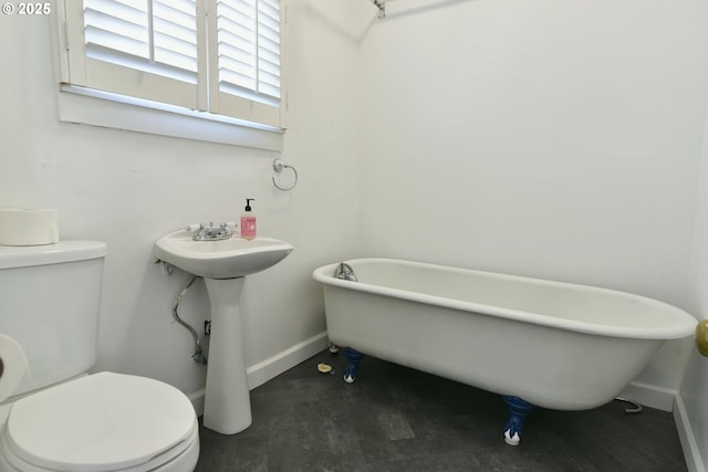 4820 SE Haig St, Portland, OR 97206 - full bathroom featuring toilet, baseboards, a soaking tub, and wood finished floors