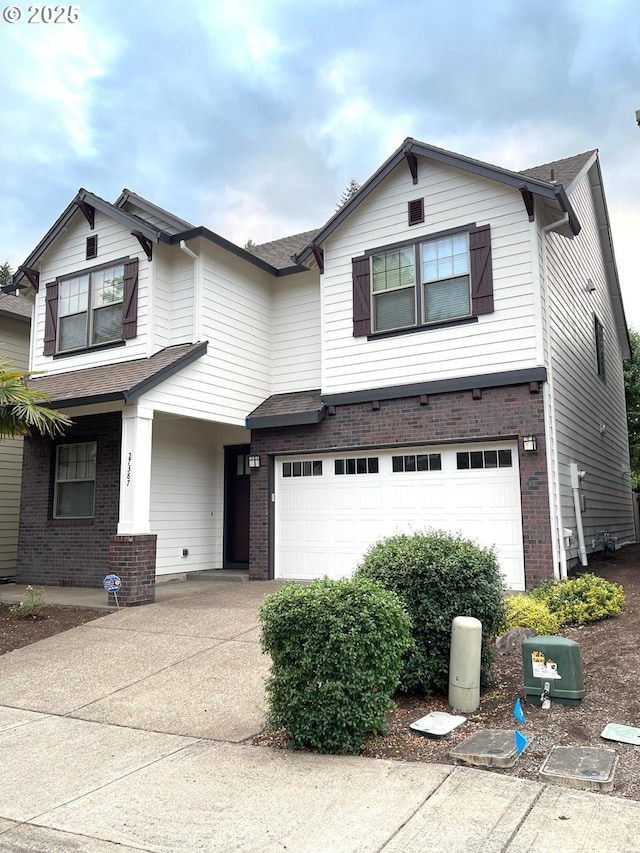 27387 SW Copper Creek Loop, Wilsonville, OR 97070 - view of front facade with a garage, brick siding, and driveway