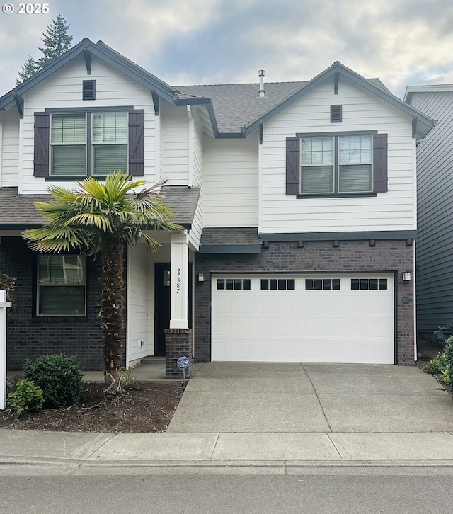 27387 SW Copper Creek Loop, Wilsonville, OR 97070 - view of front of home with brick siding, driveway, a garage, and roof with shingles