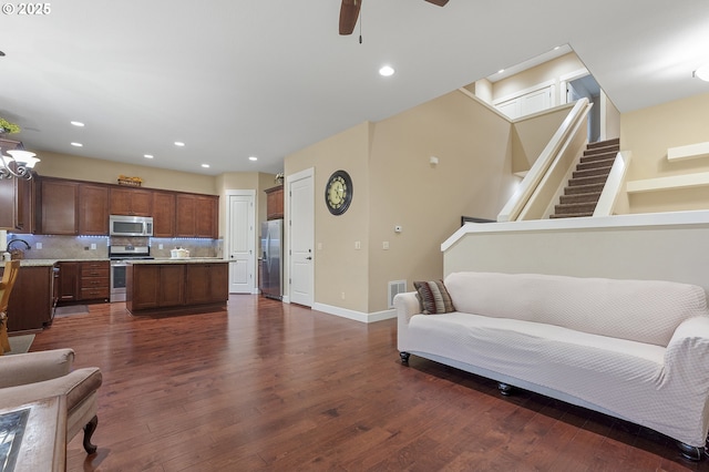 27387 SW Copper Creek Loop, Wilsonville, OR 97070 - living room featuring dark wood-style floors, a ceiling fan, stairway, and recessed lighting