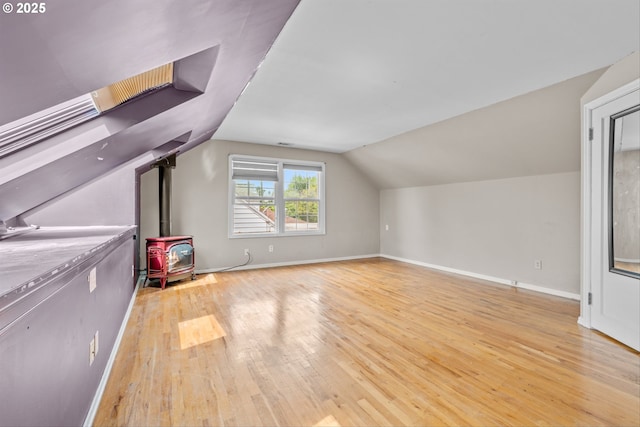 4715 N Willamette Blvd, Portland, OR 97203 - additional living space featuring wood finished floors, a wood stove, and vaulted ceiling