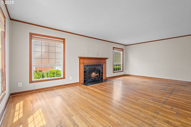 4715 N Willamette Blvd, Portland, OR 97203 - unfurnished living room featuring wood-type flooring, plenty of natural light, crown molding, and a tiled fireplace