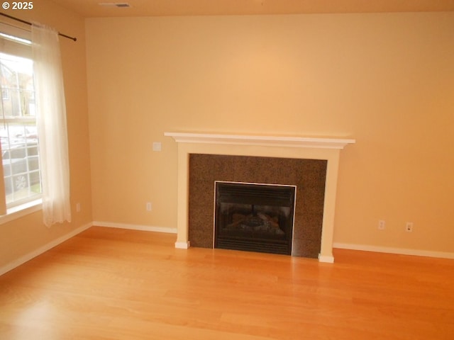 unfurnished living room with wood-type flooring