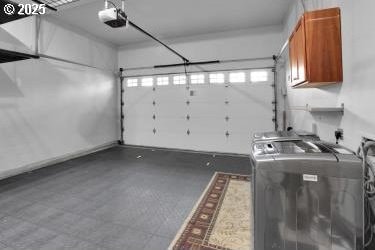 garage with washer / dryer and a garage door opener