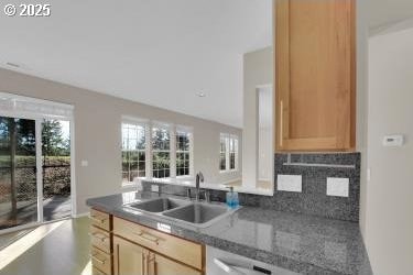 kitchen featuring sink, backsplash, and light brown cabinets