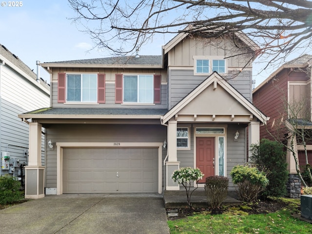 craftsman-style home with concrete driveway, board and batten siding, and an attached garage