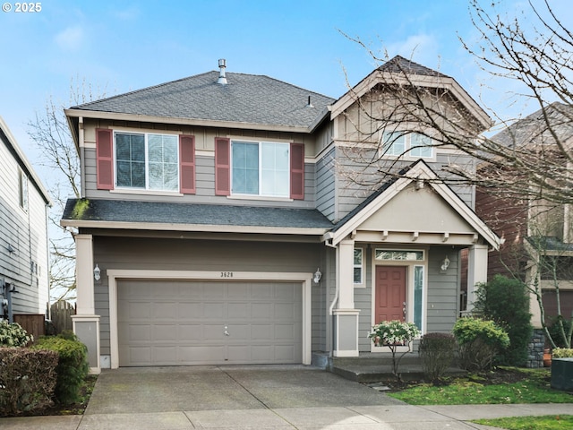 view of front of house with an attached garage, driveway, and a shingled roof