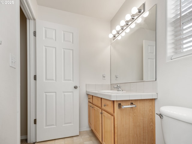 bathroom with toilet and vanity