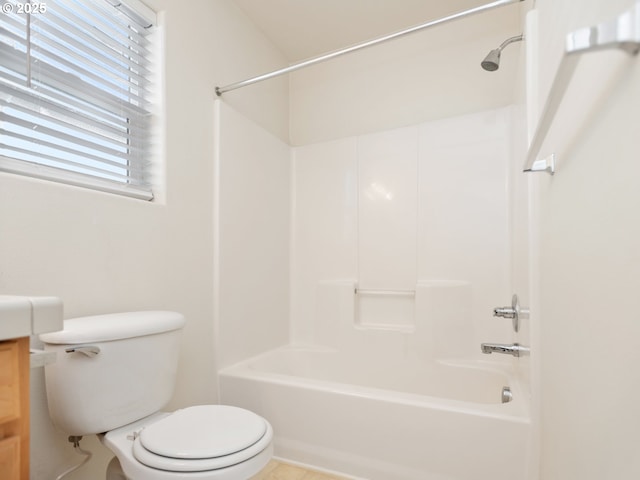 bathroom with toilet,  shower combination, and vanity