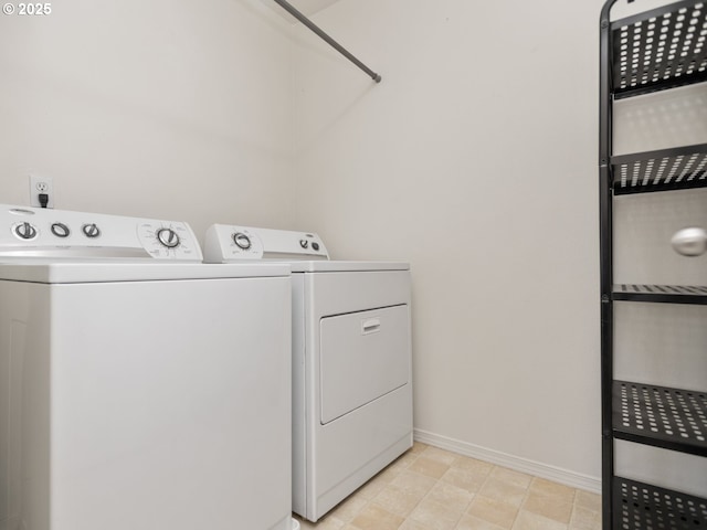 clothes washing area with laundry area, baseboards, and separate washer and dryer