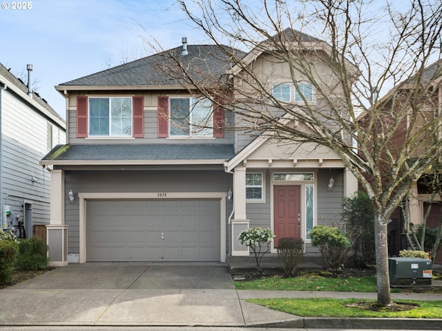 view of front of home featuring concrete driveway, roof with shingles, and an attached garage