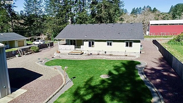 rear view of property featuring view of wooded area