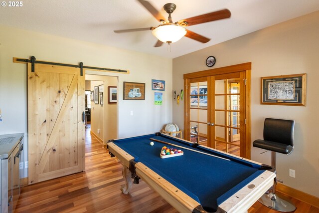 6065 Cherry Heights Rd, The Dalles, OR 97058 - game room featuring a ceiling fan, wood finished floors, a barn door, billiards table, and baseboards