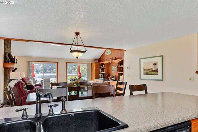 71848 Northshore Dr, Birkenfeld, OR 97016 - kitchen featuring a textured ceiling, open floor plan, pendant lighting, and a sink