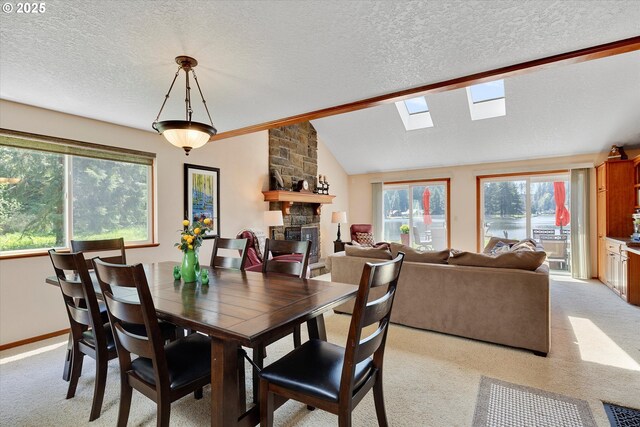 71848 Northshore Dr, Birkenfeld, OR 97016 - dining room featuring a textured ceiling, light colored carpet, lofted ceiling with skylight, and a fireplace