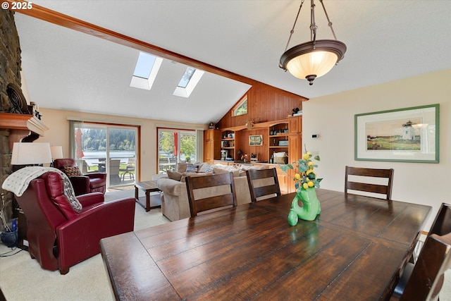71848 Northshore Dr, Birkenfeld, OR 97016 - dining area featuring wooden walls, light colored carpet, and vaulted ceiling with skylight
