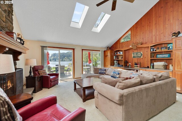 71848 Northshore Dr, Birkenfeld, OR 97016 - living room featuring ceiling fan, light colored carpet, a skylight, wood walls, and high vaulted ceiling