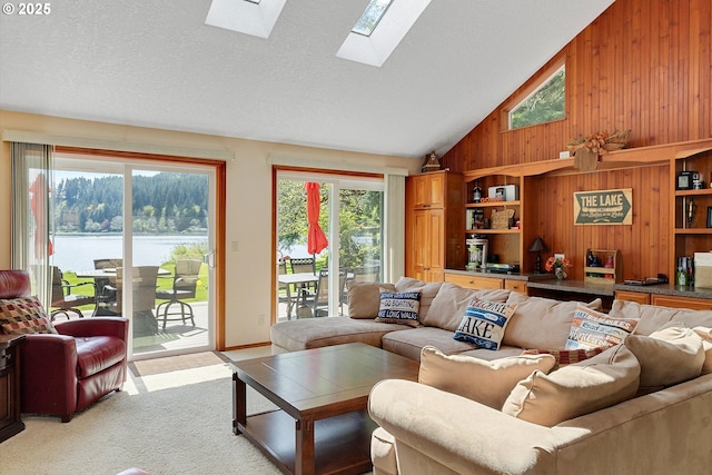 71848 Northshore Dr, Birkenfeld, OR 97016 - living area with wooden walls, a water view, plenty of natural light, and a skylight