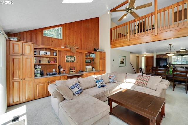 71848 Northshore Dr, Birkenfeld, OR 97016 - living area featuring light colored carpet, stairs, wooden walls, and a wealth of natural light