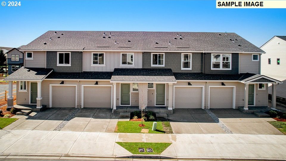 view of property featuring driveway, roof with shingles, an attached garage, and cooling unit