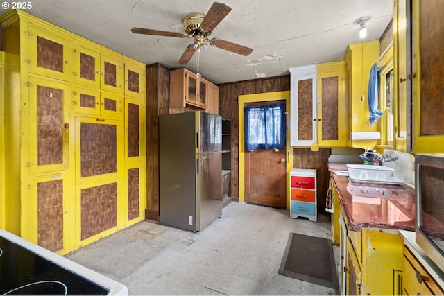 721 Columbia Blvd, Saint Helens, OR 97051 - kitchen featuring freestanding refrigerator, a ceiling fan, glass insert cabinets, wooden walls, and stove