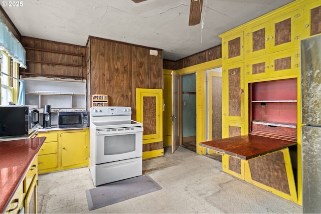 721 Columbia Blvd, Saint Helens, OR 97051 - kitchen featuring electric stove, stainless steel microwave, a ceiling fan, wood walls, and refrigerator