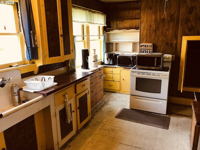 kitchen featuring stainless steel microwave, light flooring, and wall oven