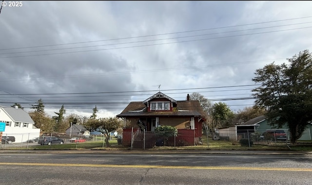 view of front facade featuring a fenced front yard and brick siding