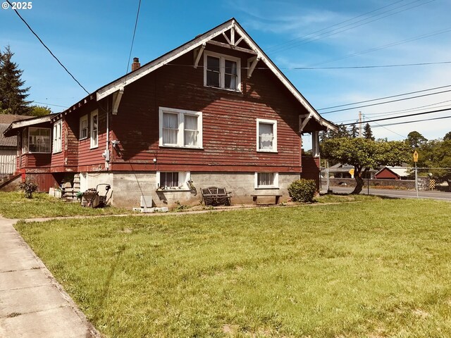 view of side of property with a yard
