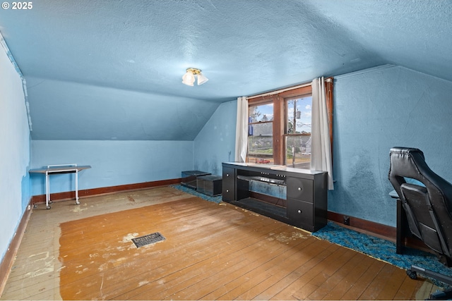 721 Columbia Blvd, Saint Helens, OR 97051 - additional living space with wood-type flooring, a textured ceiling, and lofted ceiling