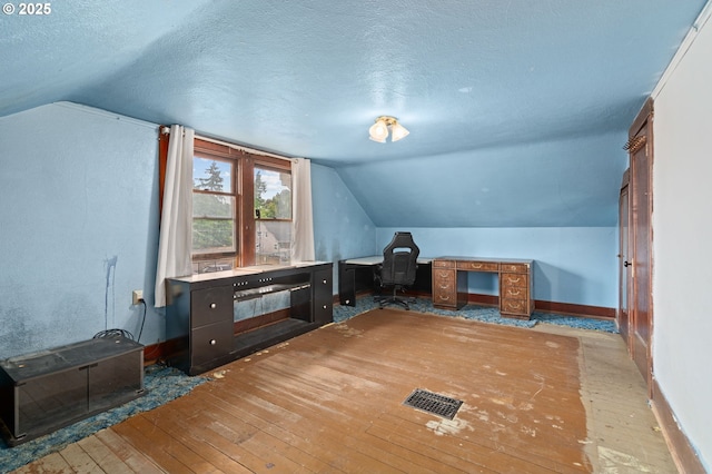 721 Columbia Blvd, Saint Helens, OR 97051 - additional living space featuring lofted ceiling, a textured ceiling, hardwood / wood-style flooring, and an office area